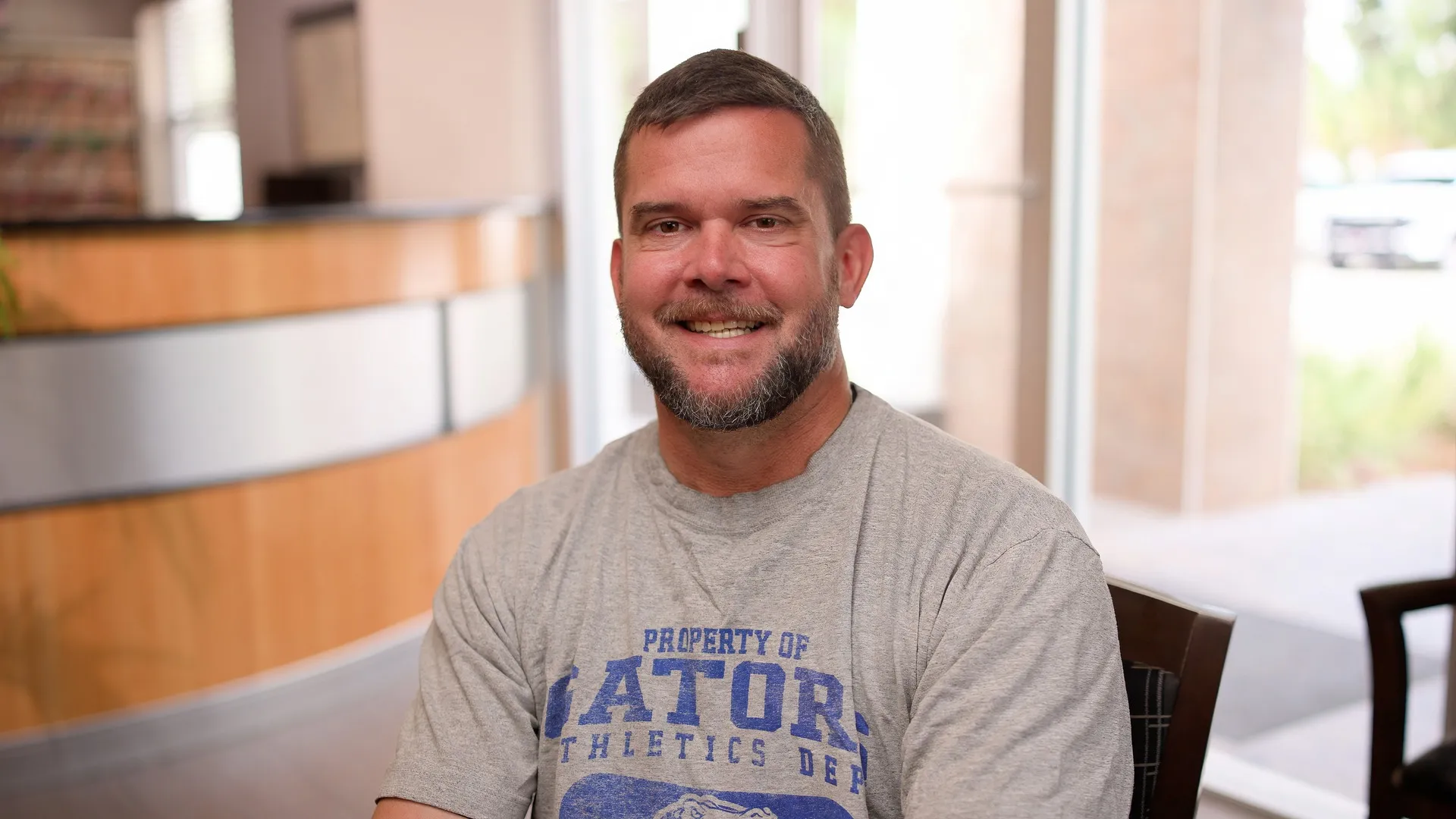 Darren, a Cardinal Point Dental patient, smiling to camera in the office lobby — teeth cleanings and exams in Jacksonville, FL