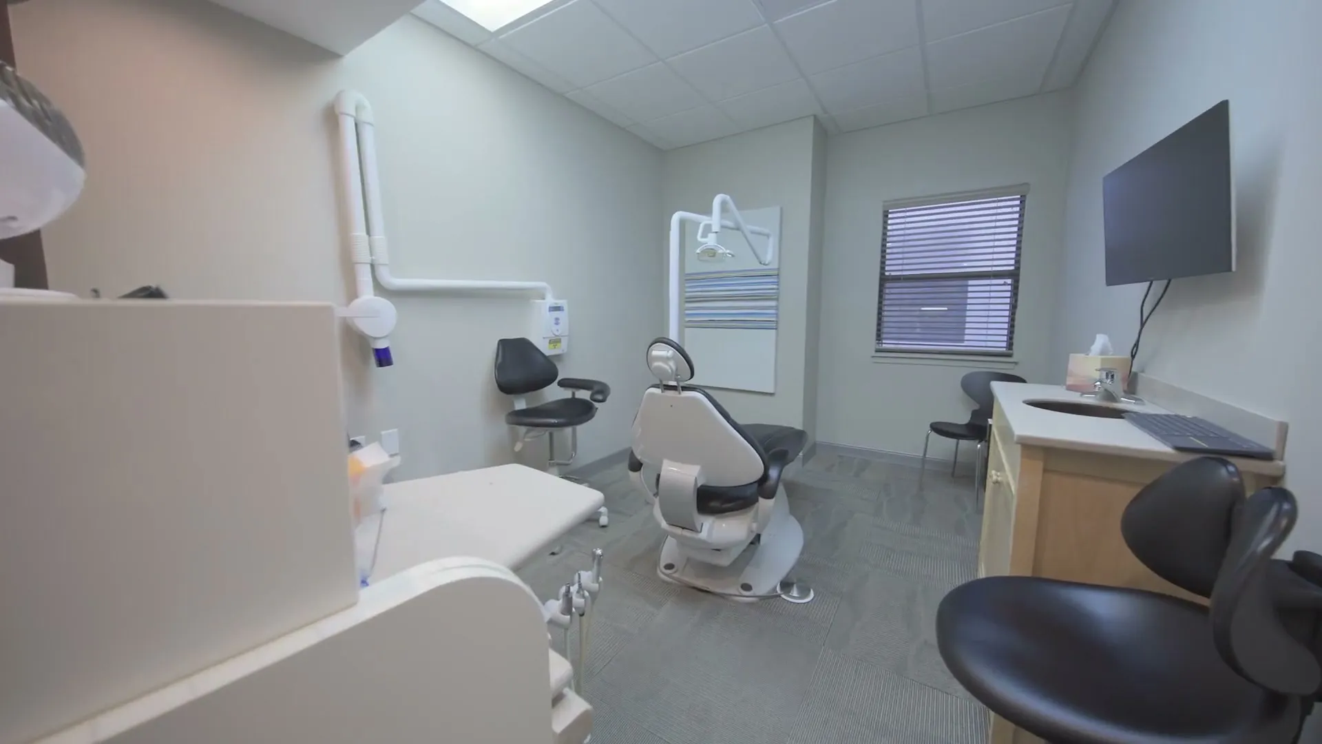 A treatment room with a dental chair and monitor at Cardinal Point Dental, Jacksonville, FL (dental sealants)