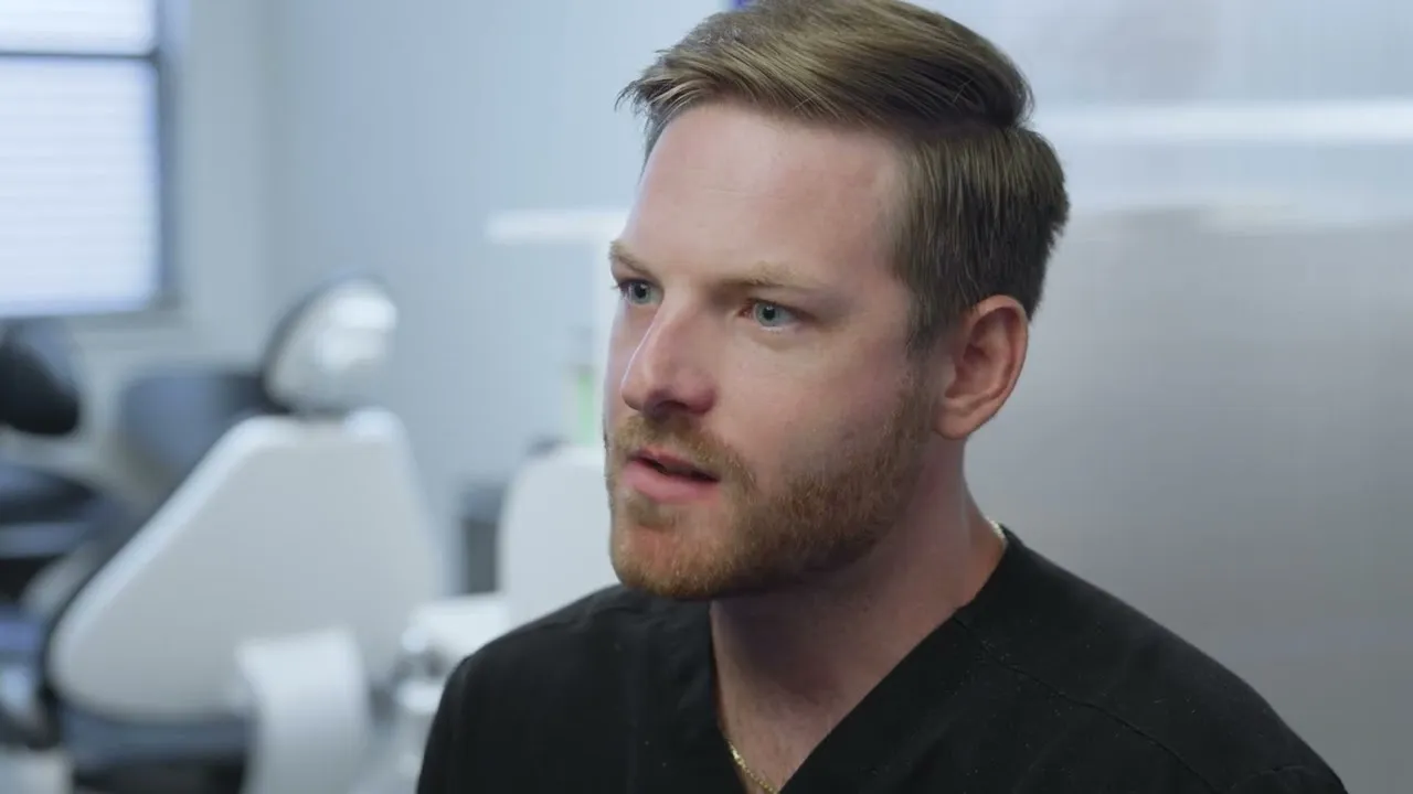 Dr. Dillon Hernandez speaking to camera in a Cardinal Point Dental exam room, at a Jacksonville, FL dental office offering teeth cleanings and implant treatment