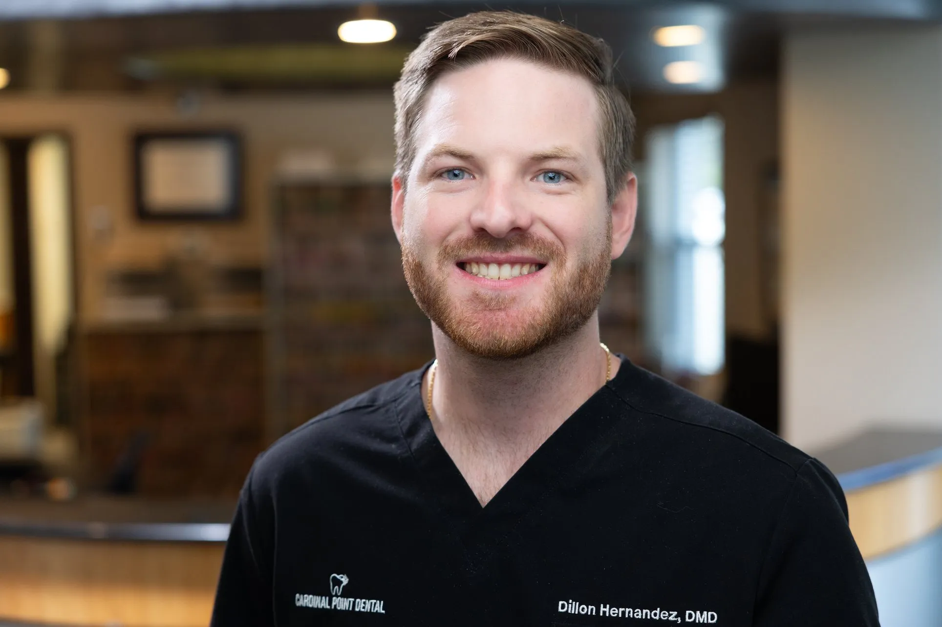 Dr. Dillon Hernandez, DMD, smiling in the lobby of Cardinal Point Dental, Jacksonville, FL (teeth cleanings, exams and implant treatment)