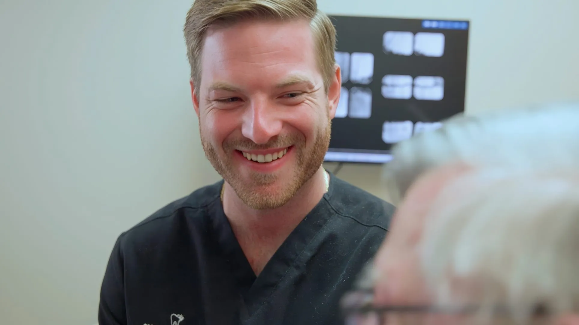 Dr. Dillon Hernandez smiling during a visit with a patient at Cardinal Point Dental, Jacksonville, FL (cavity prevention and exams)
