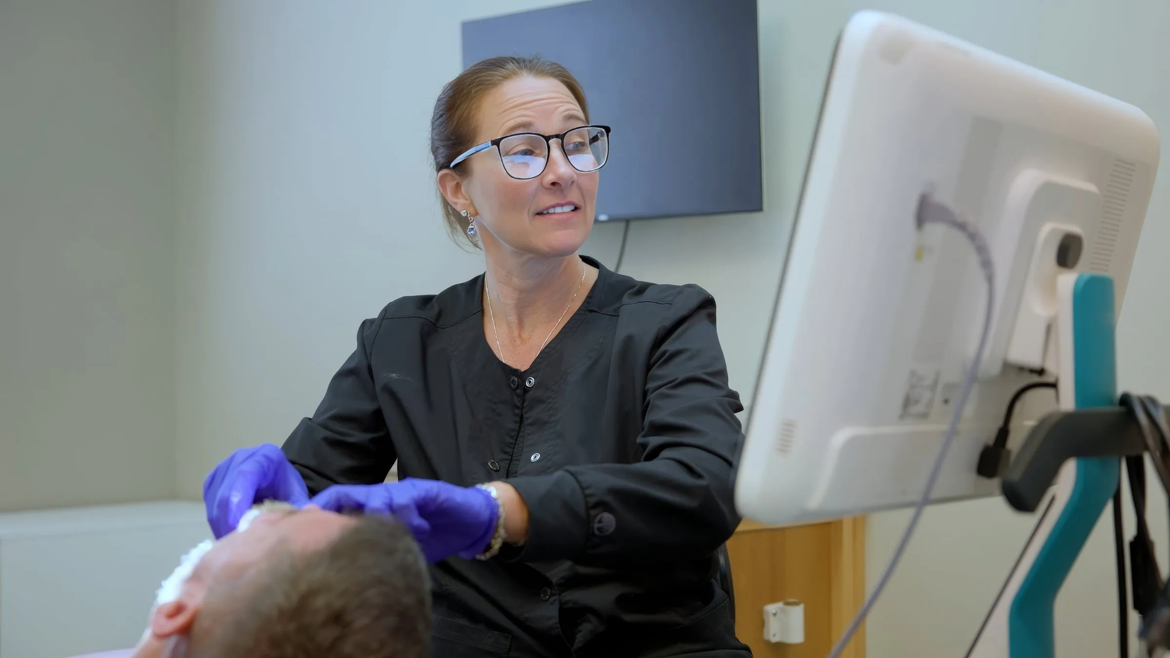 A Cardinal Point Dental team member examining a patient, at a Jacksonville, FL dental office offering teeth cleanings and exams