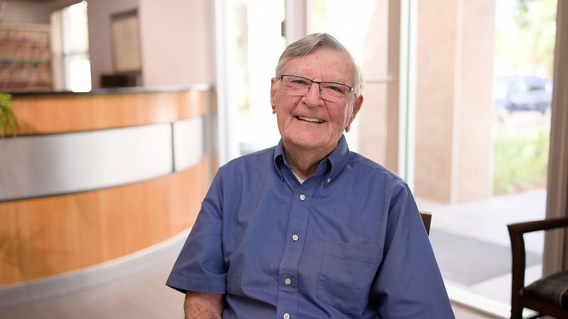 Jim, a Cardinal Point Dental patient, smiling to camera in the office lobby during a visit for teeth cleanings and exams in Jacksonville, FL