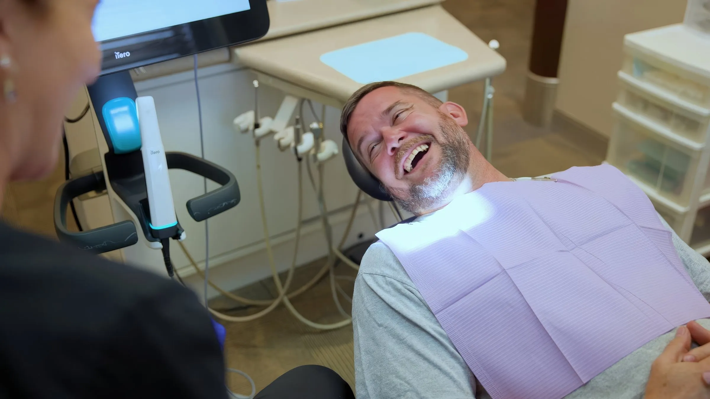 A patient laughing in the treatment chair at Cardinal Point Dental, at a Jacksonville, FL dental office offering sedation dentistry