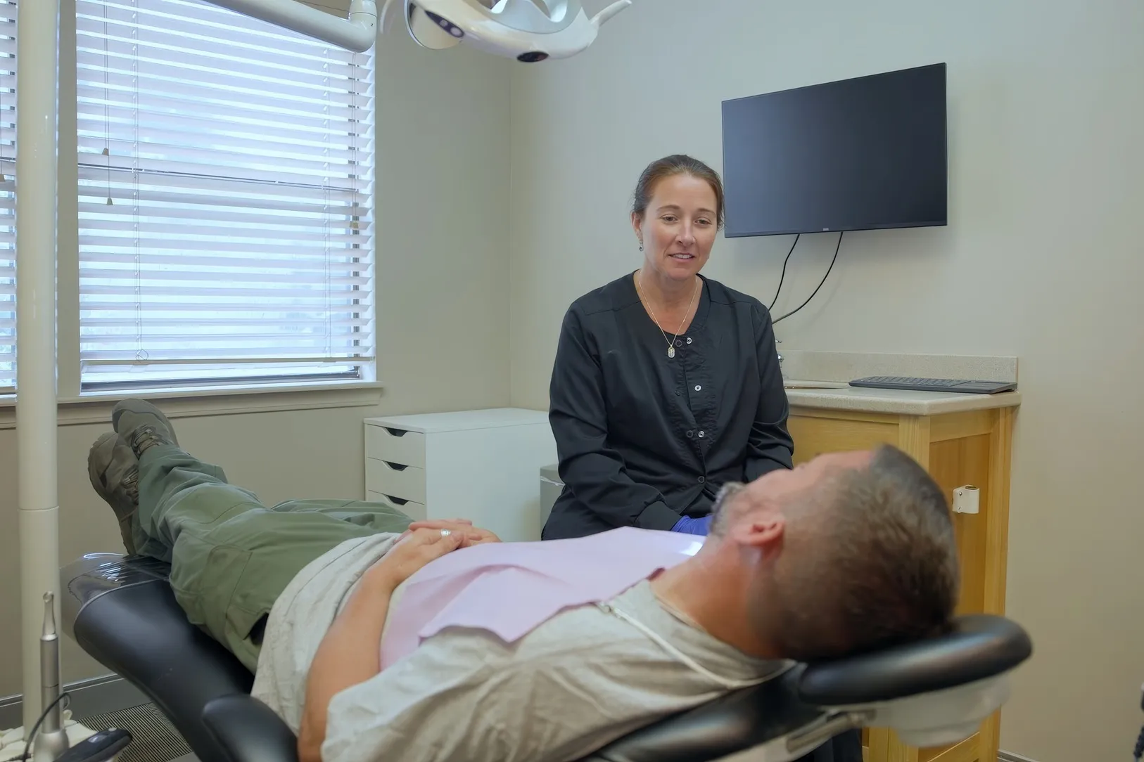 A patient relaxed in the chair with a Cardinal Point Dental team member beside them — sedation dentistry in Jacksonville, FL