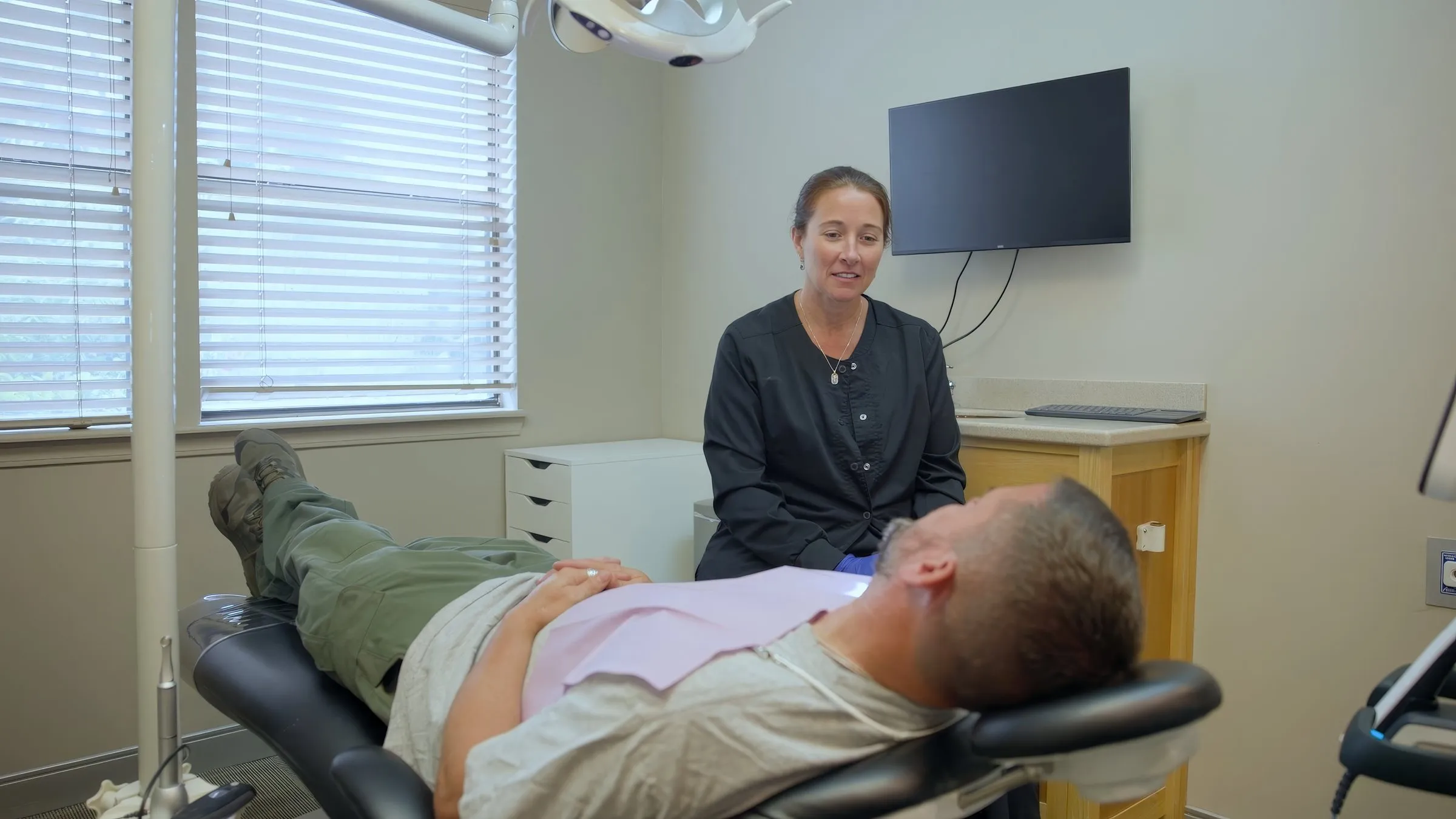 A patient relaxing in the treatment chair at Cardinal Point Dental, Jacksonville, FL (implant-supported tooth replacement)