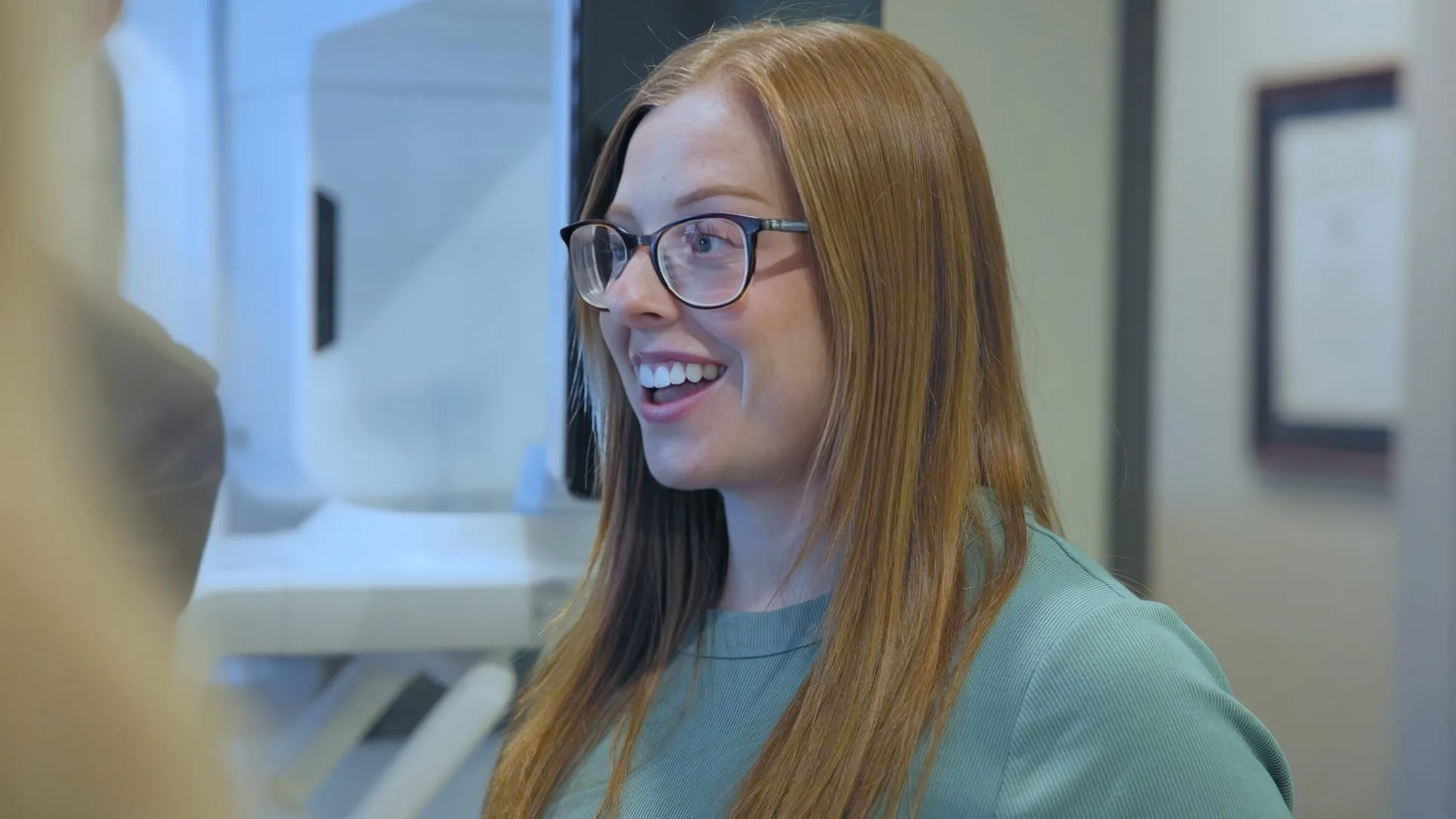 A smiling Cardinal Point Dental team member in an exam room — smile makeovers in Jacksonville, FL