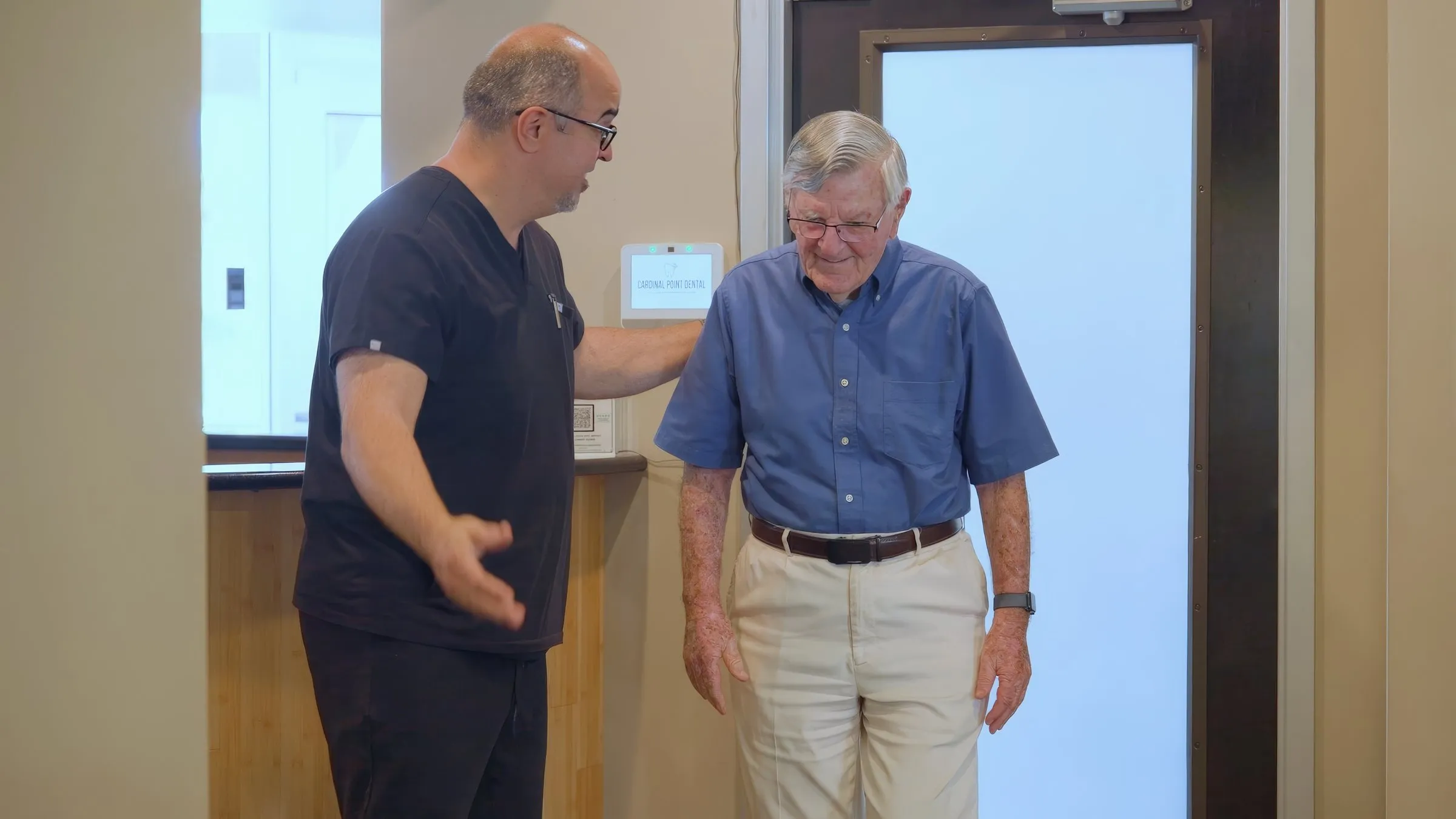 A team member welcoming an older patient into the exam area at Cardinal Point Dental — tooth extractions and other restorative care in Jacksonville, FL