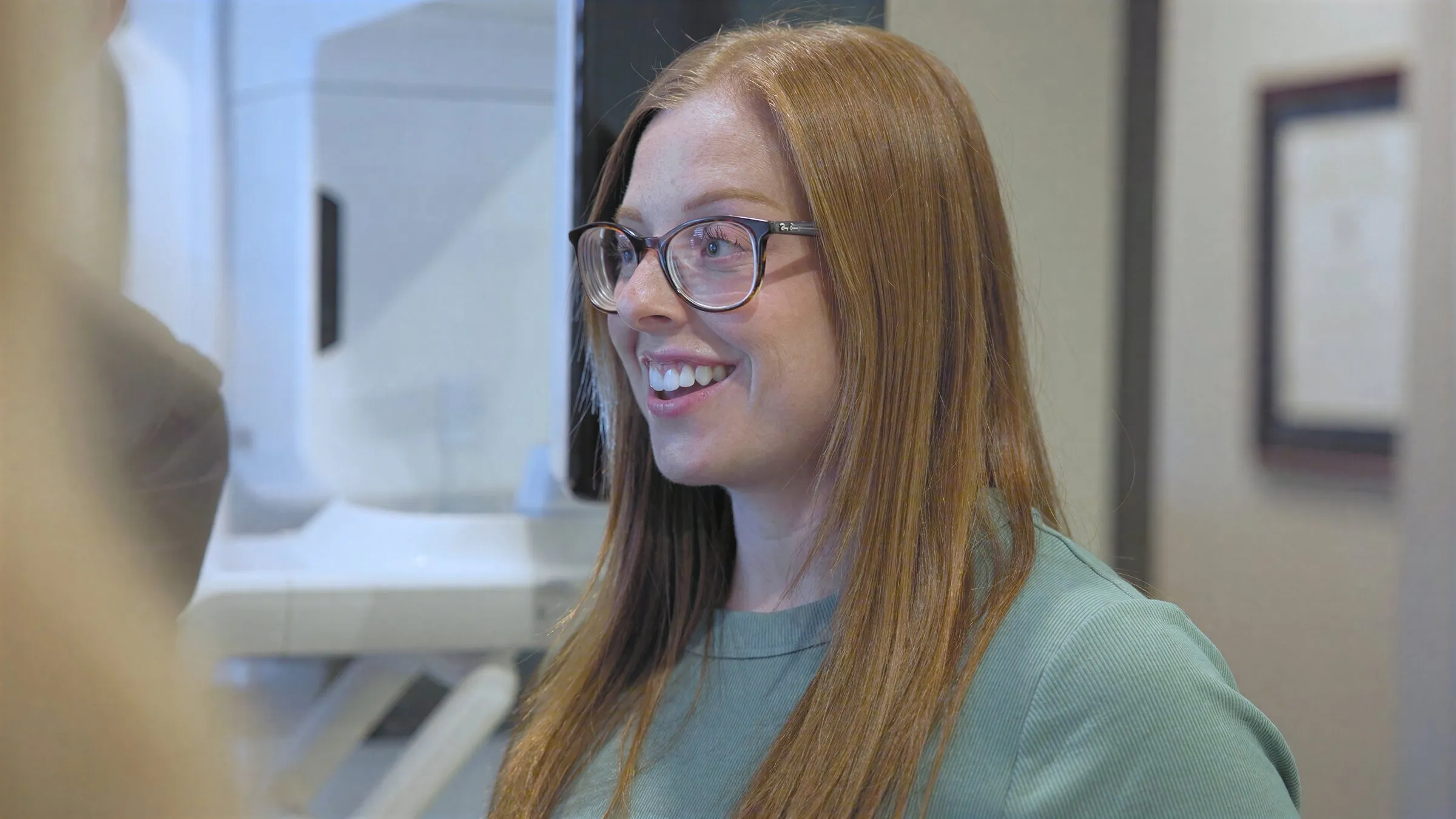 A smiling Cardinal Point Dental team member in an exam room, at a Jacksonville, FL dental office offering teeth whitening