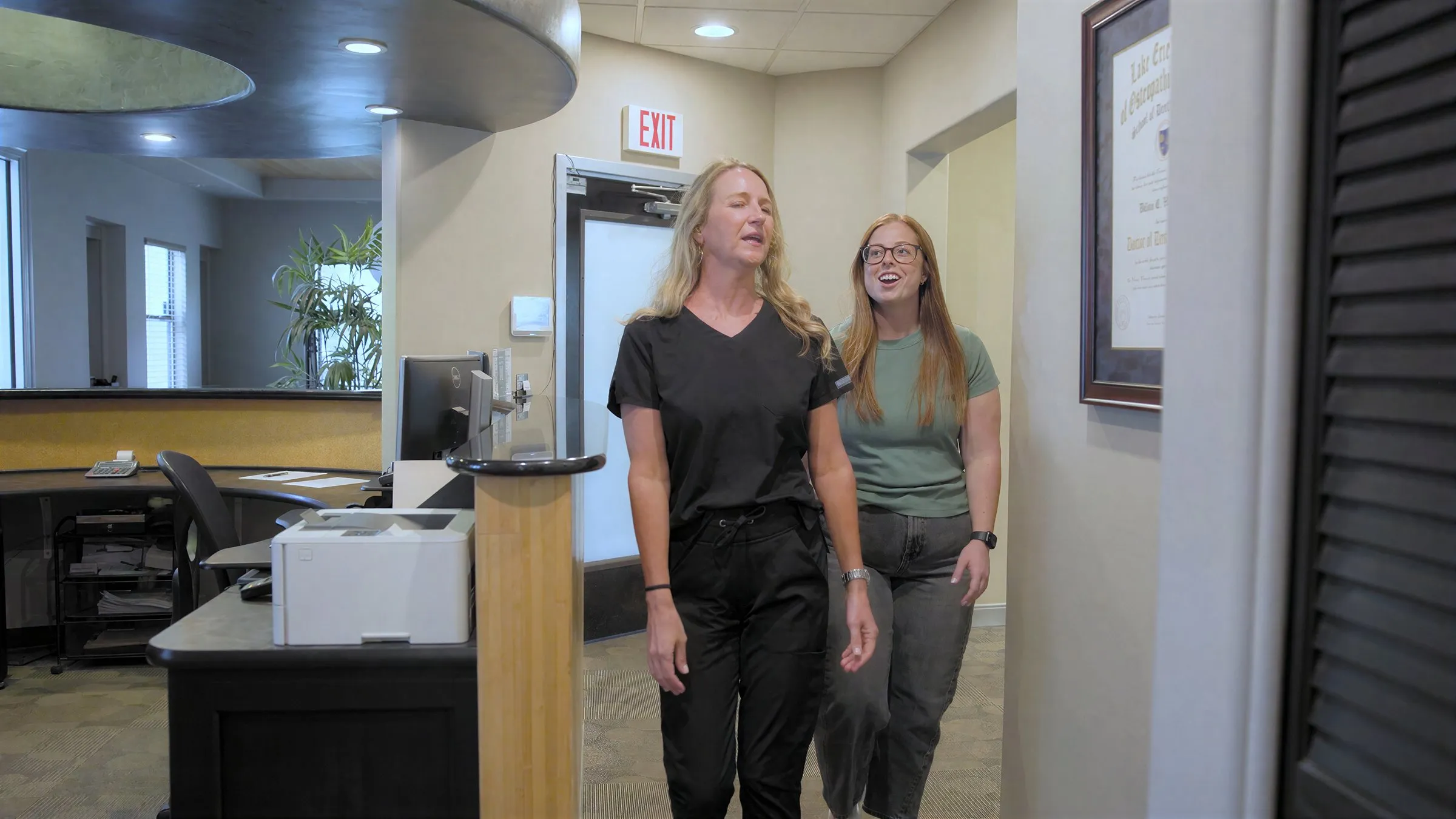 Two Cardinal Point Dental team members walking together through the office hallway — emergency dentistry in Jacksonville, FL